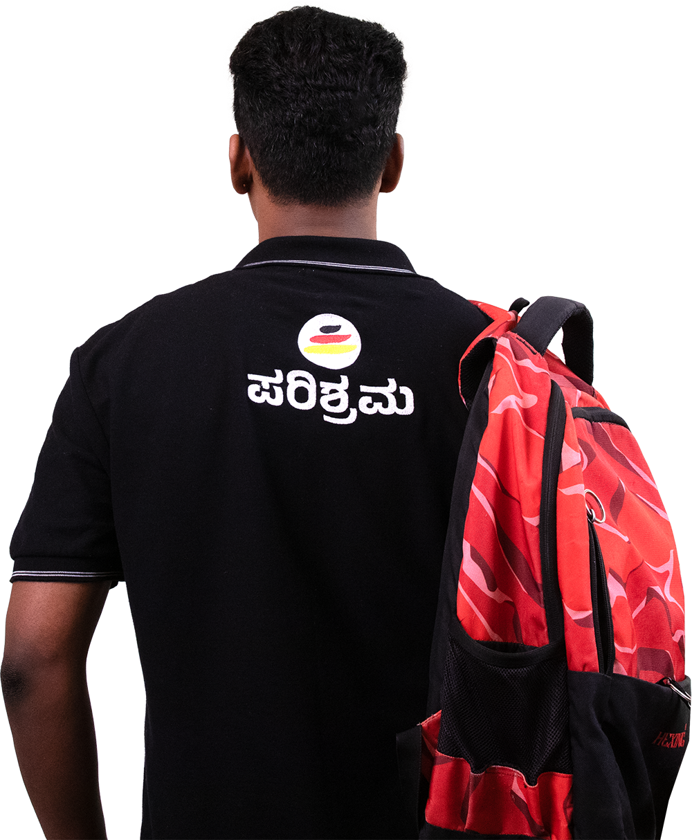 Parishrama student with backpack facing the campus